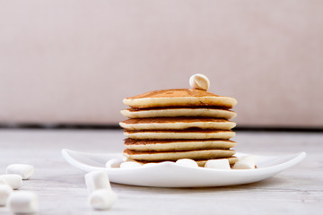 High stack of pancakes . Breakfast for the whole family .