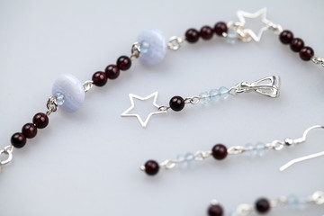 Silver jewels with colorful precious stones and light grey background