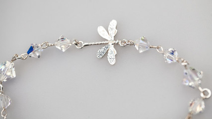 Silver jewels with colorful precious stones and light grey background