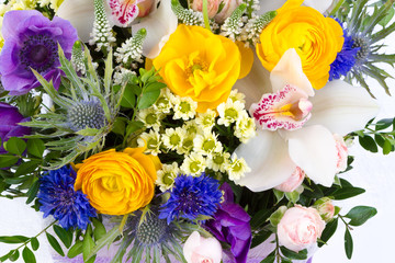 Bright buketny composition from fresh flowers, the white isolated background