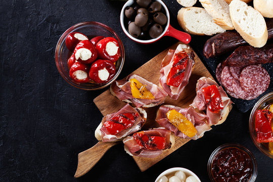 Spanish tapas with slices jamon serrano and grilled pepper. Also