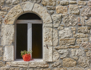 arched window on stone wall, Hydra island, Greece. Space for typing