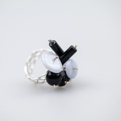 Silver rimgs with colorful precious stones and light grey background