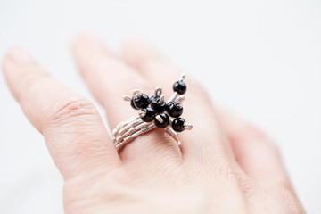 Silver jewels with onyx stones, natural leather and light grey background