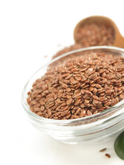 flax seeds in bowl on white