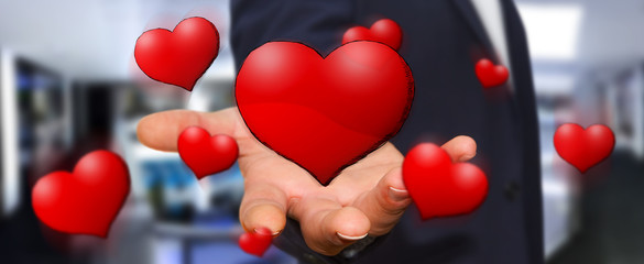 Young man holding hand drawn red heart