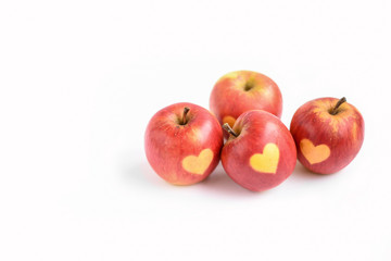  Red apples with shape of heart on a white background , cardiology, holiday  and health concept
