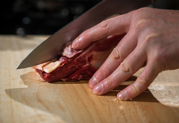 Cut a piece of meat with a knife