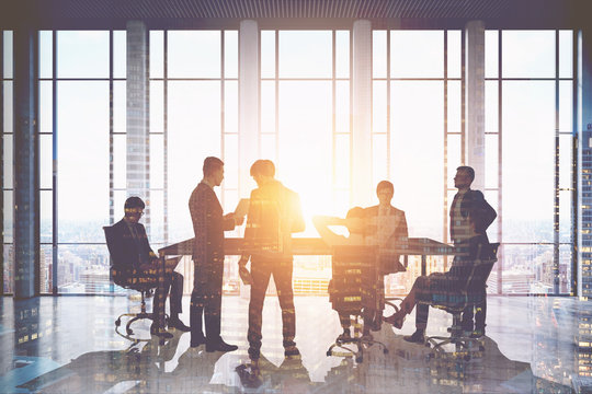 Business people meeting in skyscraper, sunlight