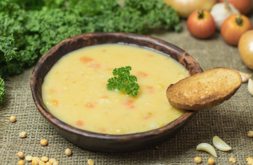 Fresh Vegetarian or vegan yellow split pea soup with parsley, on