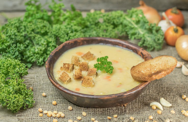 Fresh Vegetarian or vegan yellow split pea soup with parsley, on