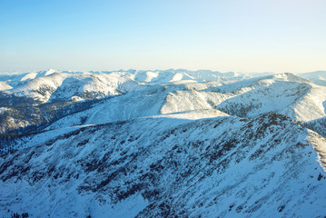 majestic winter landscape of snowy mountains with clear blue sky