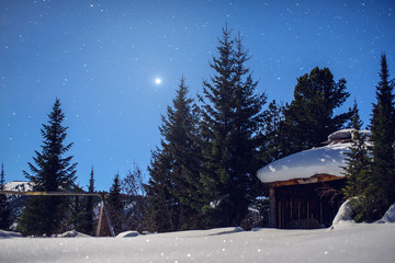 fabulous winter image of a wooden house with light