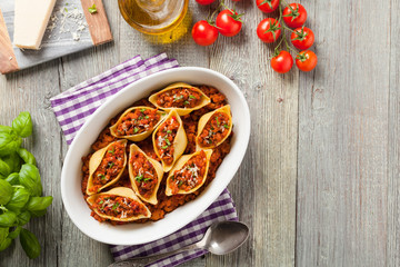 Italian pasta Conchiglioni Rigati stuffed with dry tomatoes and