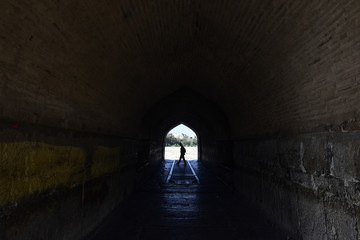 Perspective View Through a Dark Tunnel With Human Silhouette