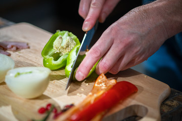 Man cuts pepper