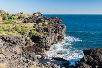 Steep black cliff in Catania, formed by ancient lava flows from volcano Etna