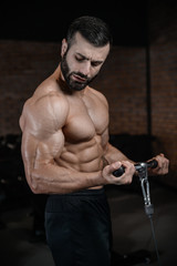 Naklejka na ściany i meble Fitness instructor handsome man in the gym gain muscle