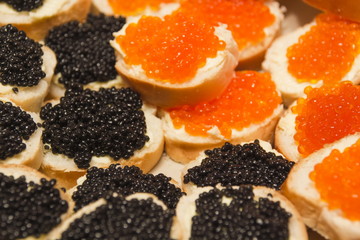 Group of snacks with red and black caviar