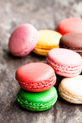 colorful  macarons on rustic wooden backrgound
