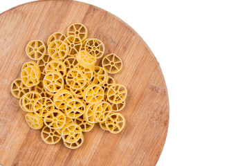 Raw unboiled pasta on the kitchen cutting board