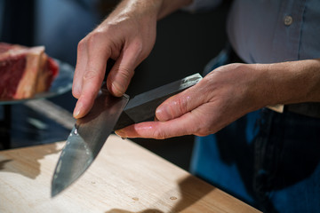 Man sharpening his knife on the bar