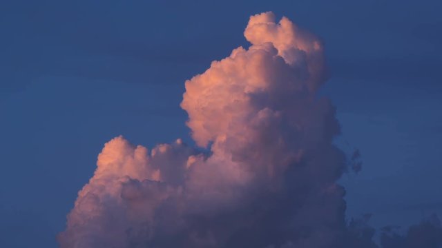 4K Time lapse close up of a red illuminated clud at sunset

