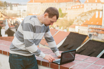 Adult male works on the computer.