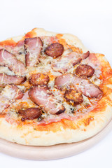 Flat lay overview of pizza with domestic ham sirloin and sausage