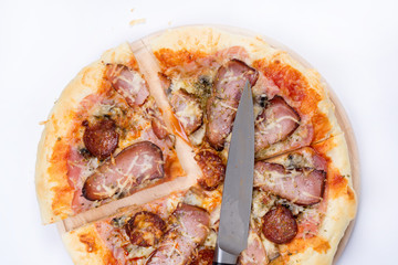 Flat lay overview of pizza with domestic ham sirloin and sausage