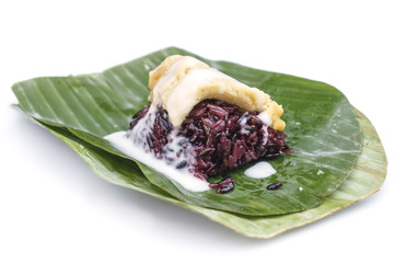 Thai custard sticky black rice dessert on banana leaf isolated o