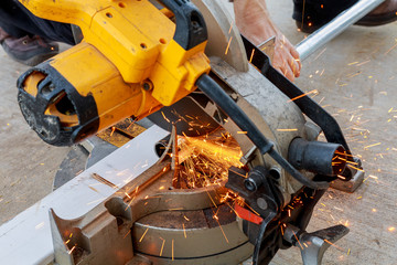 Worker grinding a metal plate