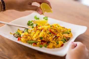 Woman eating Paella, traditional spanish seafood.