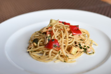 pasta salad with spaghetti, pepper, mozzarella, red onion, pine nuts