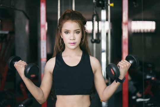 young fitness asian woman exercise with machine Cable Crossover