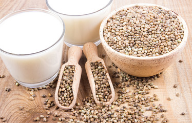 Hemp milk, seeds on wooden background . Close Up .
