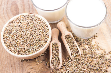 Hemp milk, seeds on wooden background . Close Up .