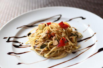 pasta salad with spaghetti, pepper, mozzarella, red onion, pine nuts