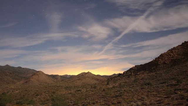 Time lapse of a desert landscape with moon shadows