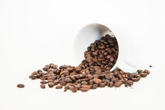 Coffee beans with cup and on white backgrounf