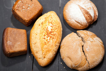 Homemade bread on a black wooden background