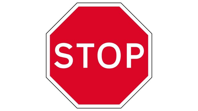 Footage of a STOP traffic sign, the shot is coming into focus and goes again out of focus