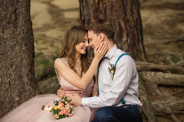 Fototapeta premium Wedding couple, beautiful bride and groom hugging with smile in face in forest after their wedding ceremony