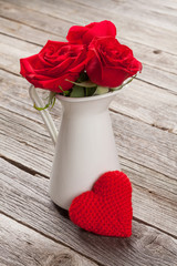 Red rose flowers in pitcher and Valentines day heart