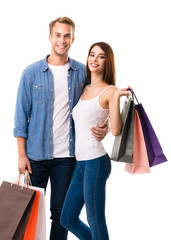 happy couple with shopping bags, on white