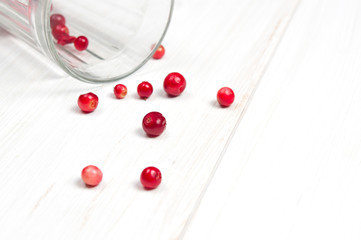 Naklejka na ściany i meble Cranberries in glass on white surface