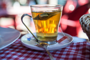glass mug with fresh and delicious tea on a table
