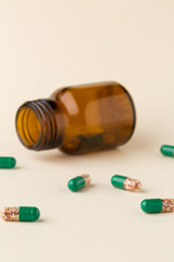Bottle of pills from the brown glass and green capsules
