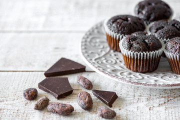 Chocolate muffins on a white rustic wooden table - selective focus, copy space