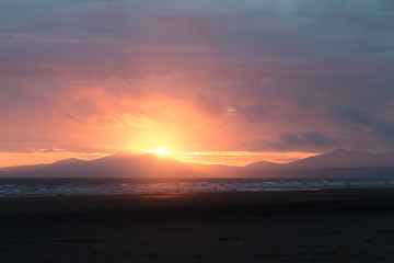Sunset Behind The Mountains At Sea